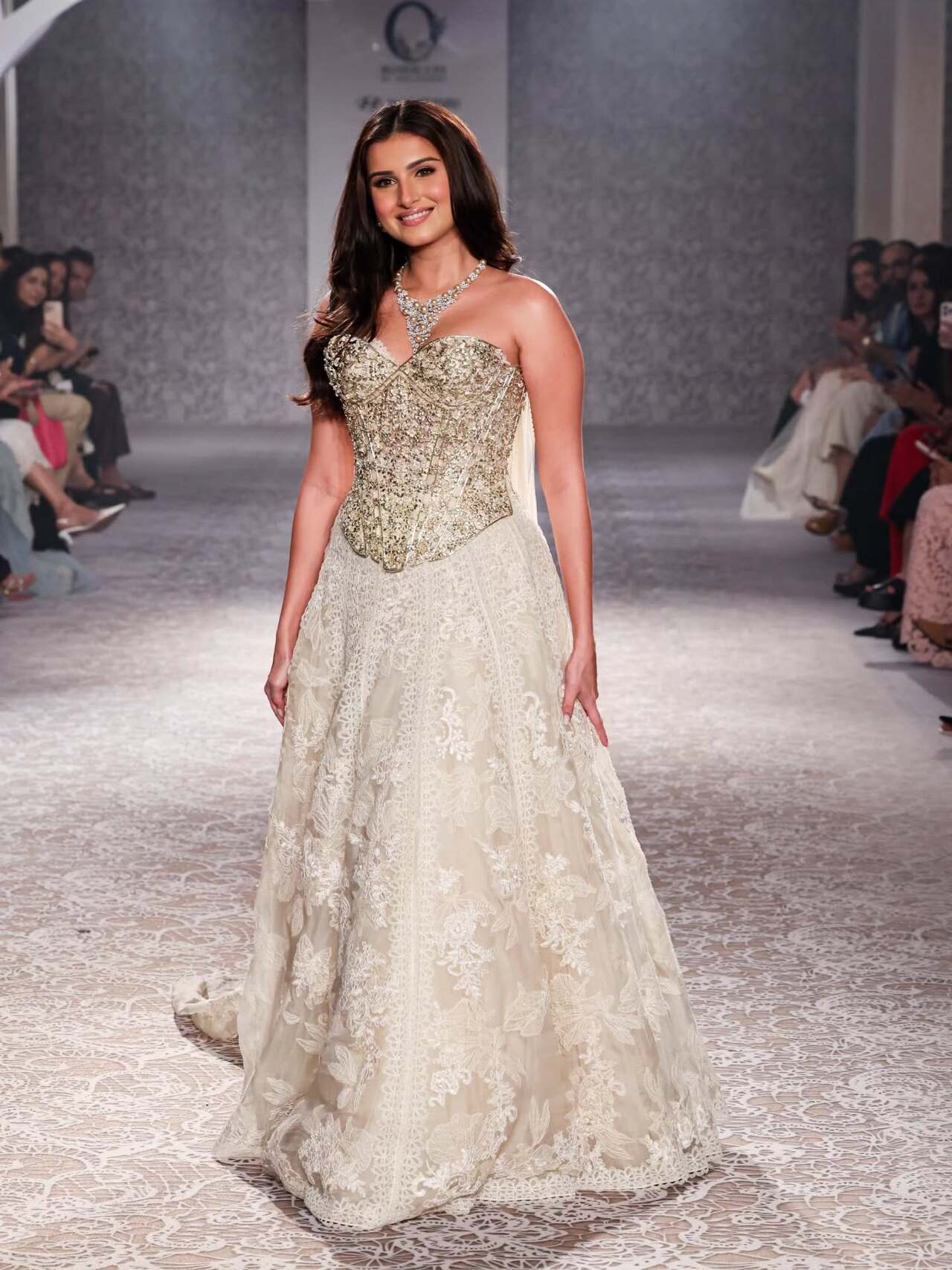 Tara Sutaria turned showstopper for Roseroom by Isha Jajodia at the India Couture Week 2025 on 24th July. She wore a heavy white net skirt with a white and gold bodice.