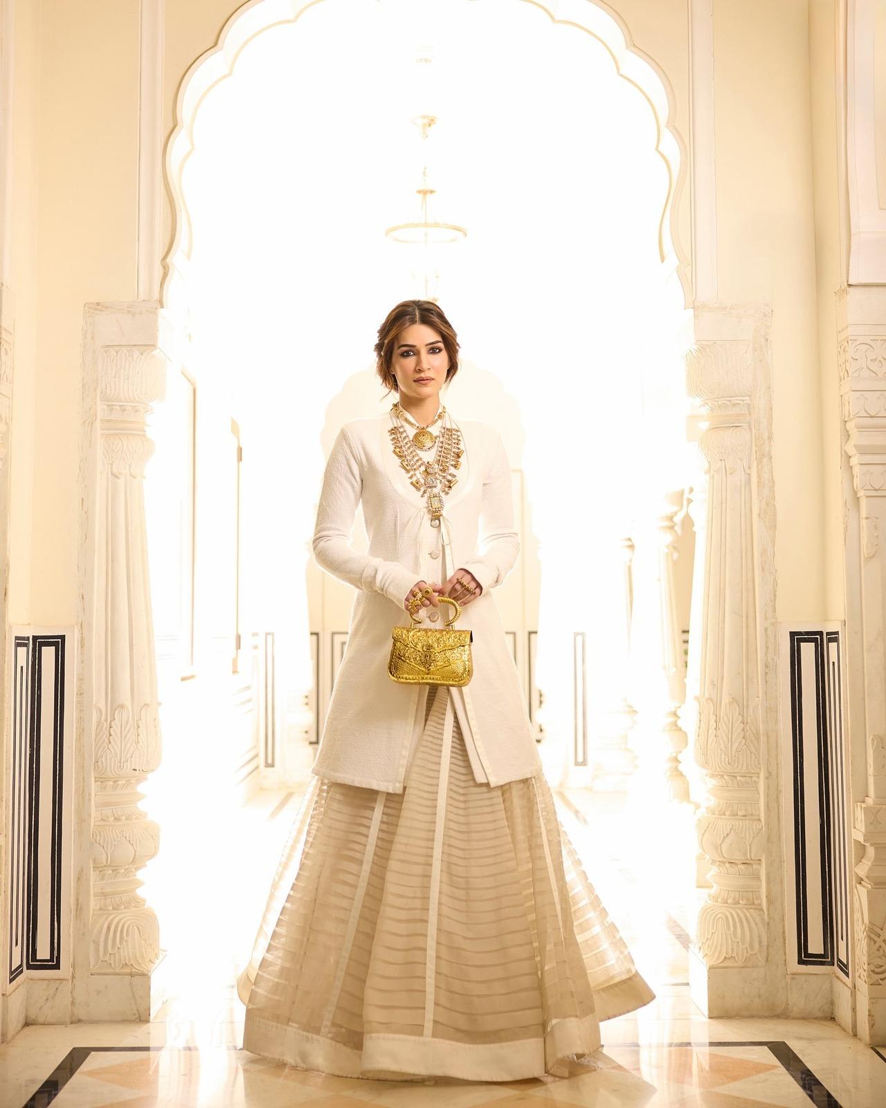 Not just western, this diva can slay in Indian outfits too, and his ivory and gold lehenga with a long coat is a proof. Kriti looks graceful and royal in this look.