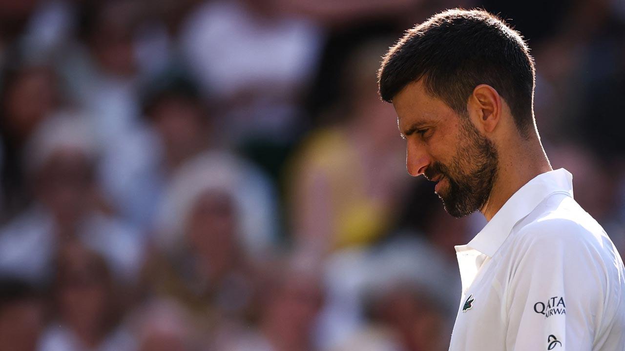 Serbia's Novak Djokovic reacts after losing the second set against Italy's Jannik Sinner during their men's singles semi-final tennis match on the twelfth day of the 2025 Wimbledon Championships at The All England Lawn Tennis and Croquet Club in Wimbledon, southwest London