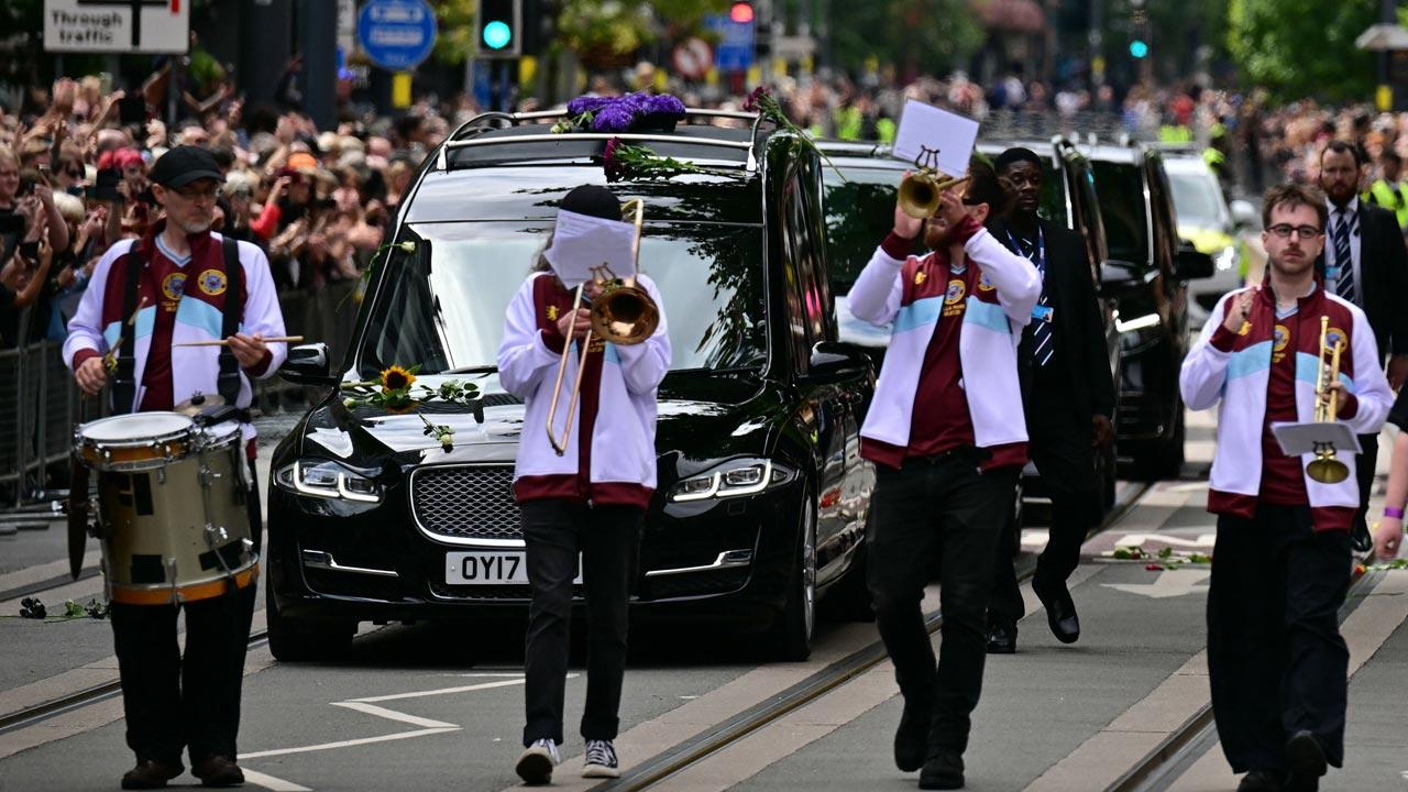 Mourners and music fans line the streets to pay their respects as the funeral cortege of Ozzy Osbourne, the late lead singer of Black Sabbath, makes its way through Birmingham, central England. Pics/AFP