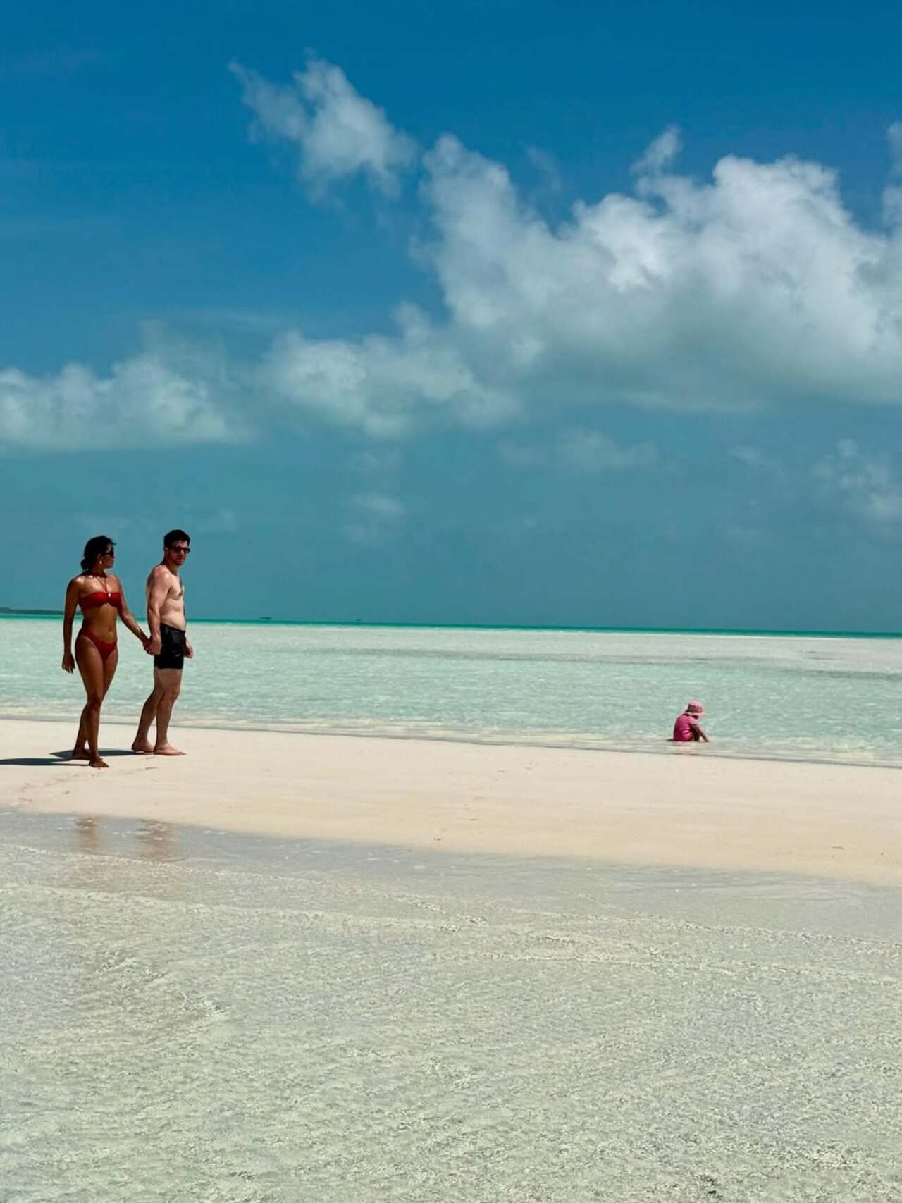 That peaceful moment: The duo share a peaceful moment as they chill by the sea, while their little one ejoys a dip