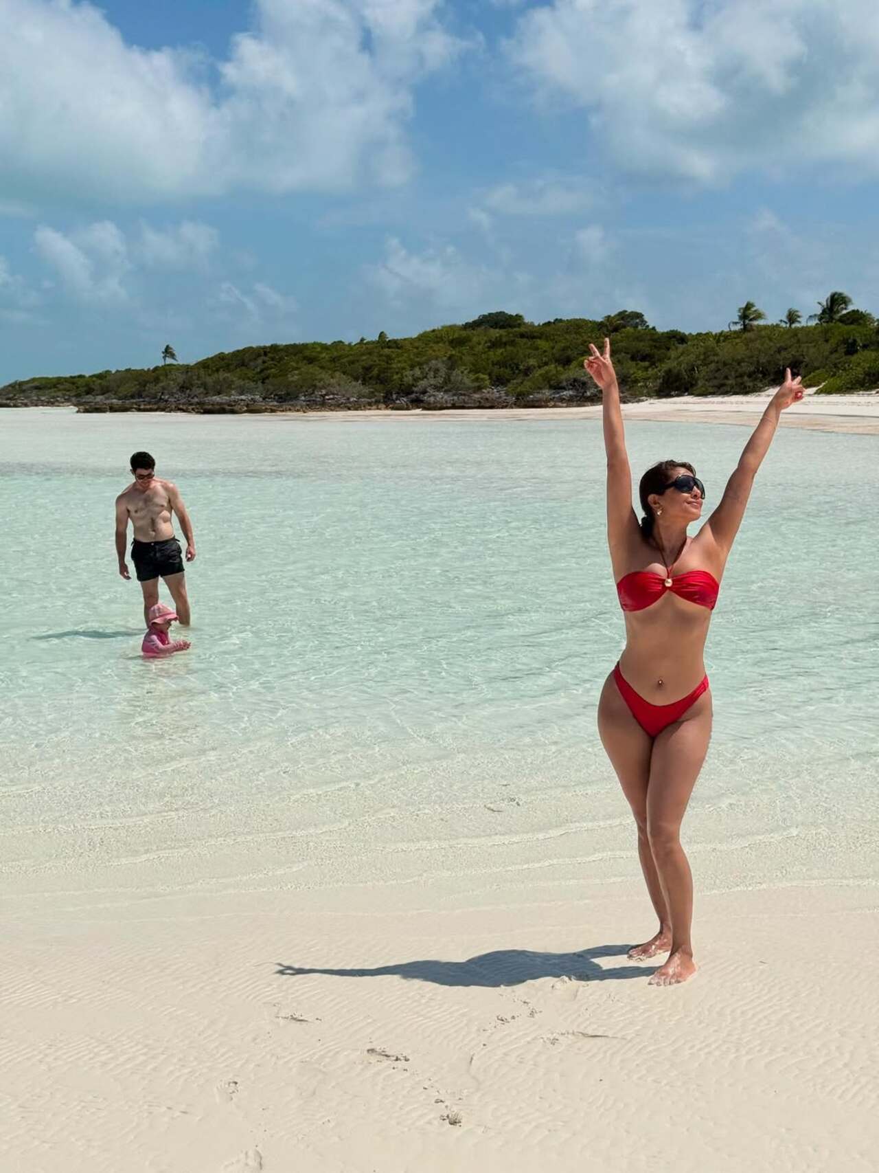 Guess who is photo bombing? Priyanka picks a red bikini for the sunny day at the beach. As she gets a picture clicked, there's someone photo-bombing her click