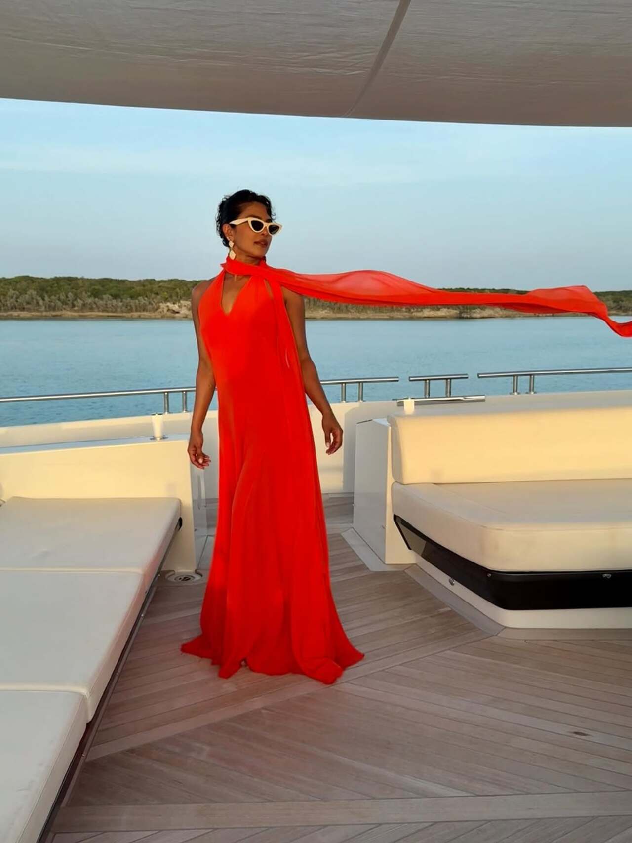 Queen is here: Take cues from Priyanka over her beach vacay outfits, the actress nails the red gown, which is perfect for the date 