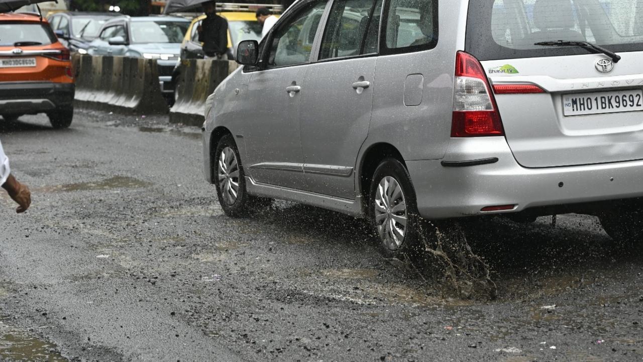 IN PHOTOS: Vehicles wade through potholes as heavy rains lash Mumbai
