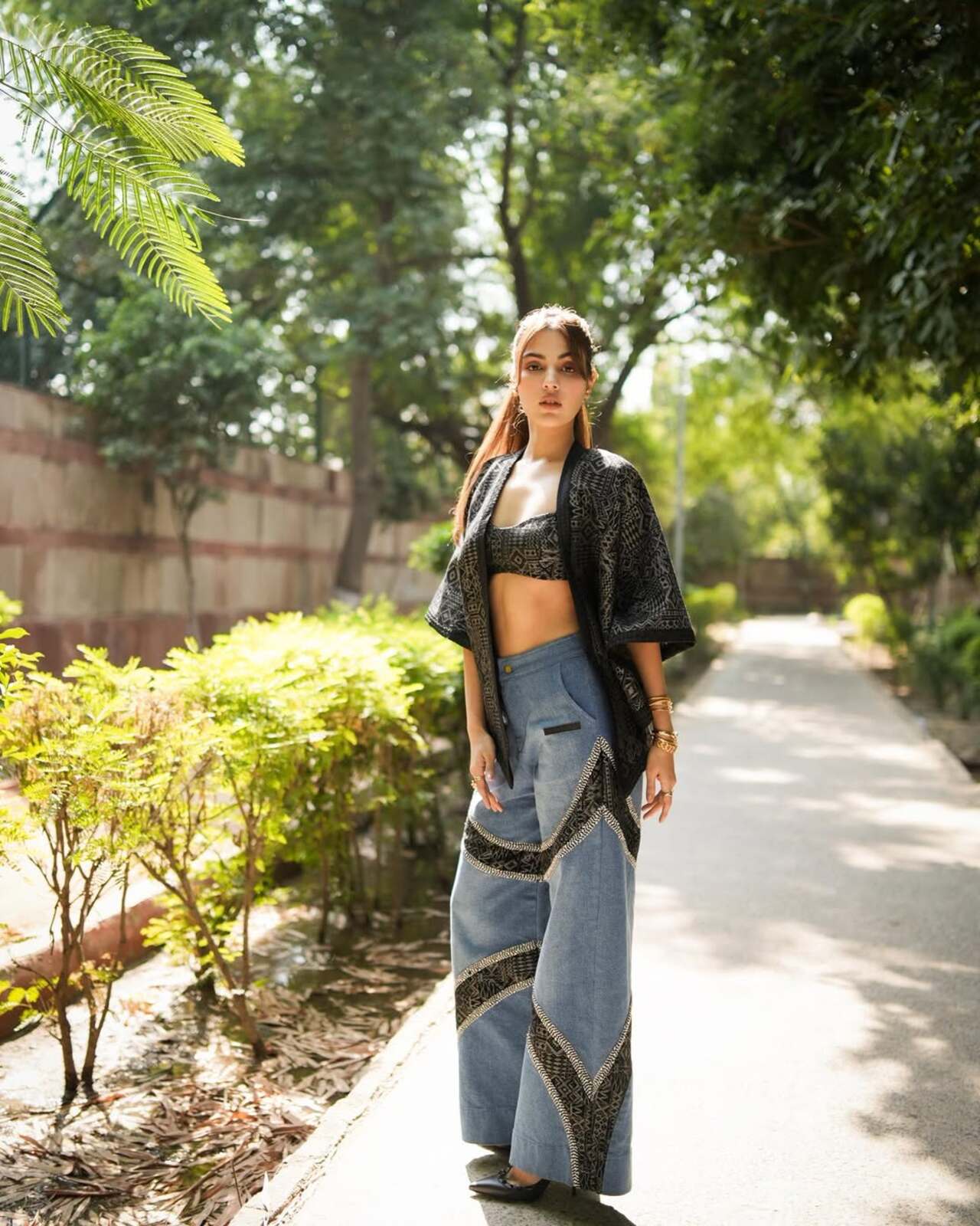 These flared denims, slashed with tribal patchwork, speak rebellion. Paired with a structured bralette and kimono jacket, it’s resortwear with a streetwise twist. Think Goa meets Paris Fashion Week