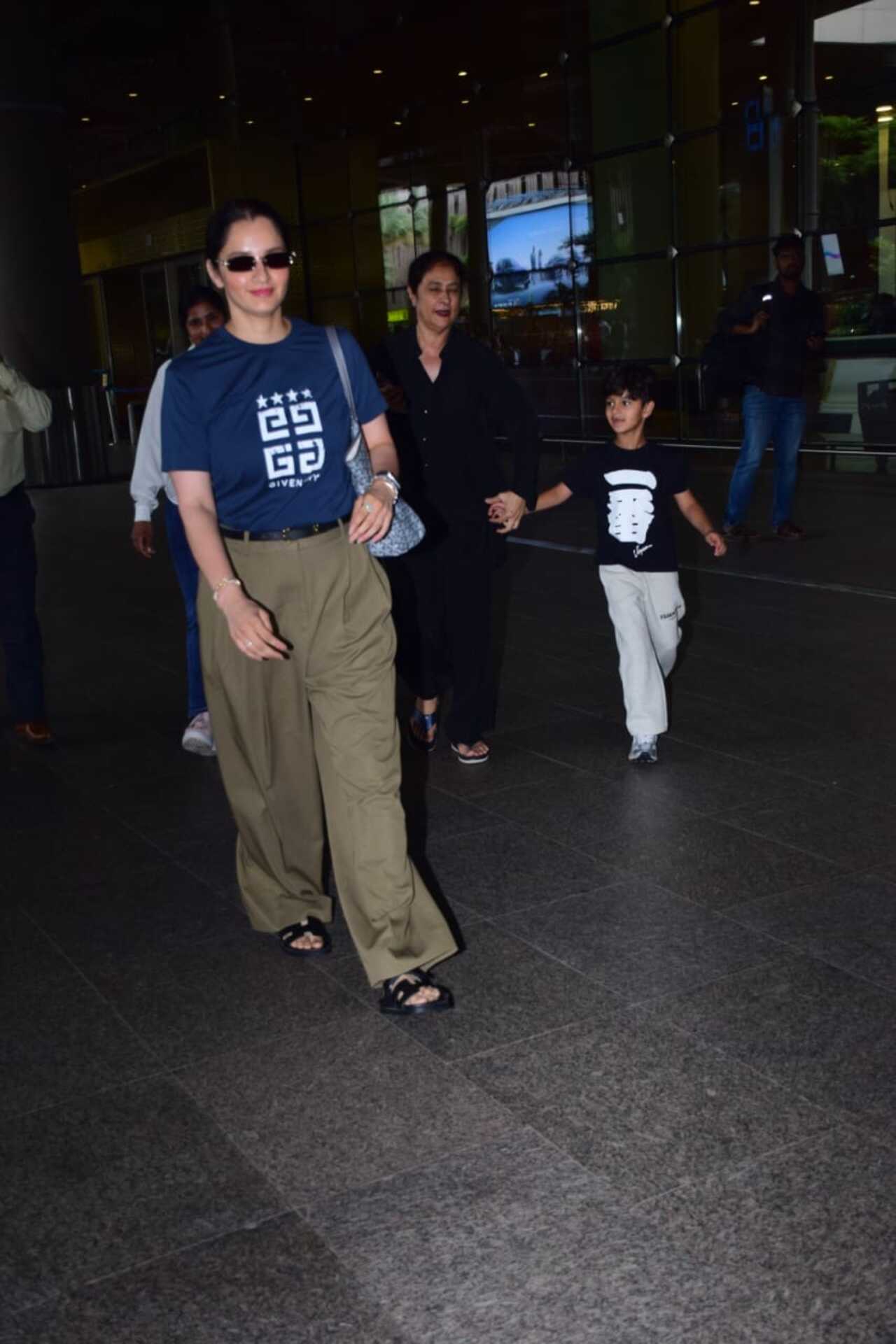 Sports player Saina Nehwal was also spotted at the airport with her son. She chose to be in her comfy look in a casual t-shirt and bottoms. The mother-son duo was seen exiting the airport.