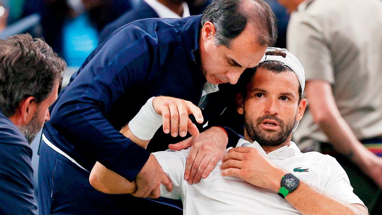 Grigor Dimitrov gets medical attention before retiring on Monday. Pic/AFP