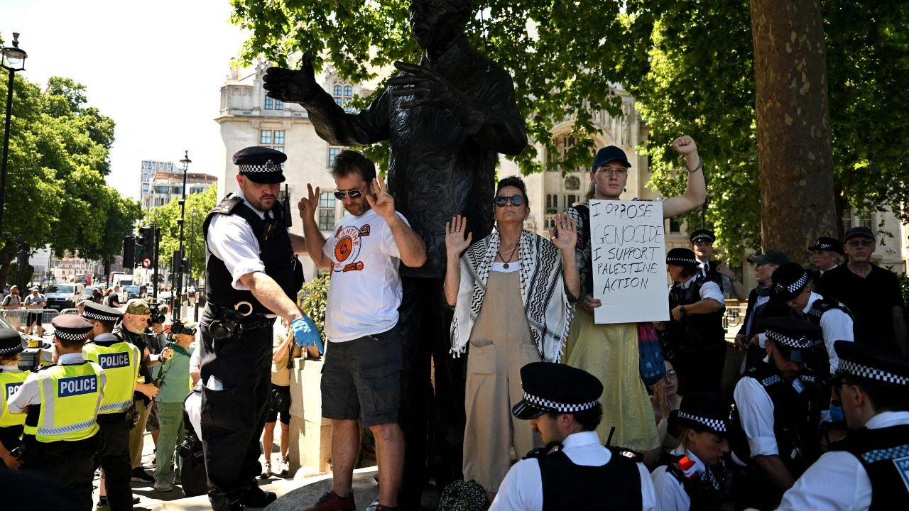 Two groups gathered underneath both the statues of Indian independence leader Mahatma Gandhi and South Africa's first post-apartheid president, Nelson Mandela, in Parliament Square