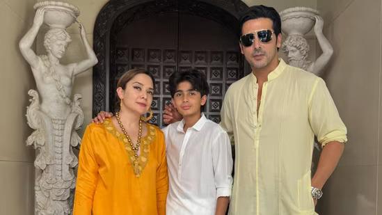 Zayed Khan poses happily with his wife and son in this picture as they look bright and radiant in yellow and white outfits.