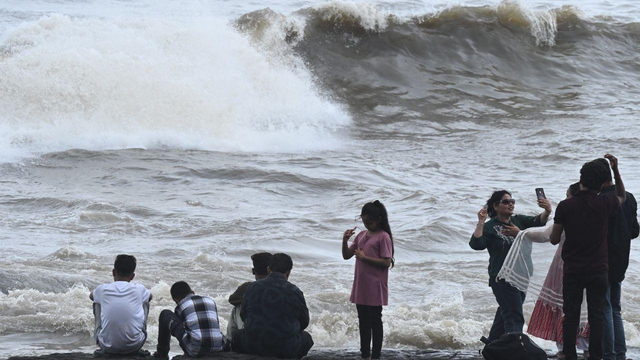 Mumbaikars revel in the monsoon magic, soaking in the breezy charm and dramatic waves along the city’s scenic coastline