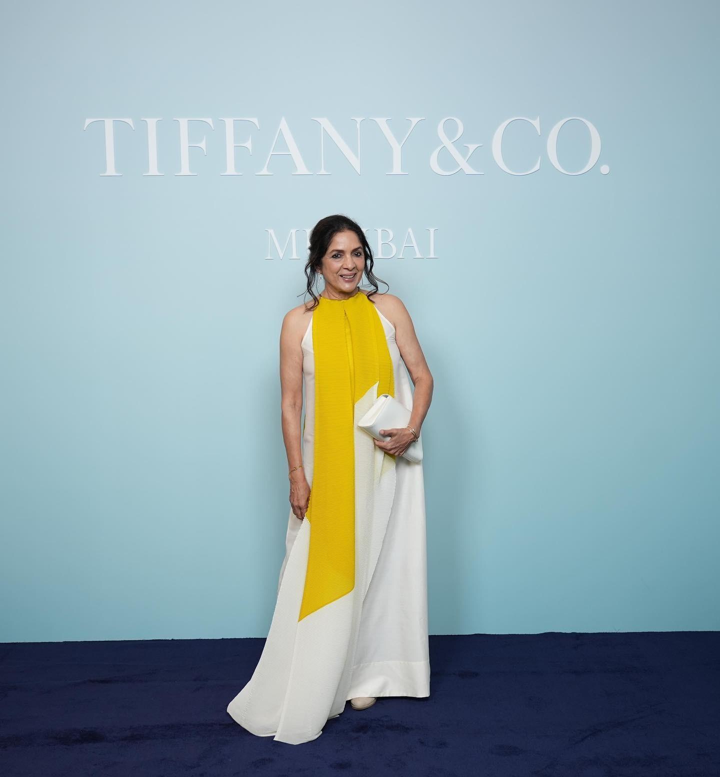 Neena looks absolutely graceful in this white halter neck flowy gown. The yellow and white harmony is just too perfect. 