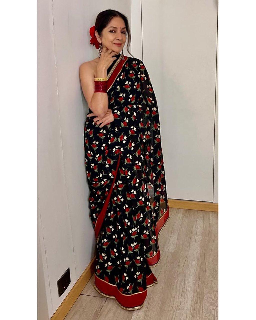 The veteran actress certainly knows how to rock the classic saree looks. We love how she pairs the red and black floral saree with a rose in her hair bun and matching red bangles, creating the perfect harmony of colours. 