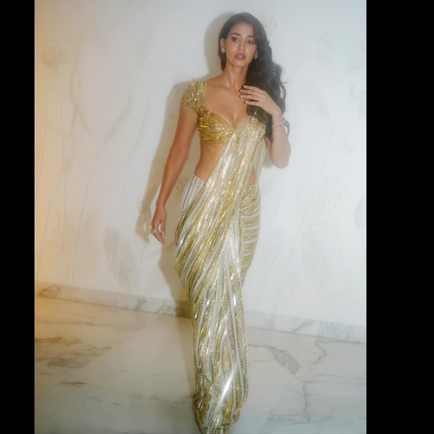 Disha made a statement in this white and gold saree, which she wore at an event. Needless to say, she was among the most beautiful guests at the event.