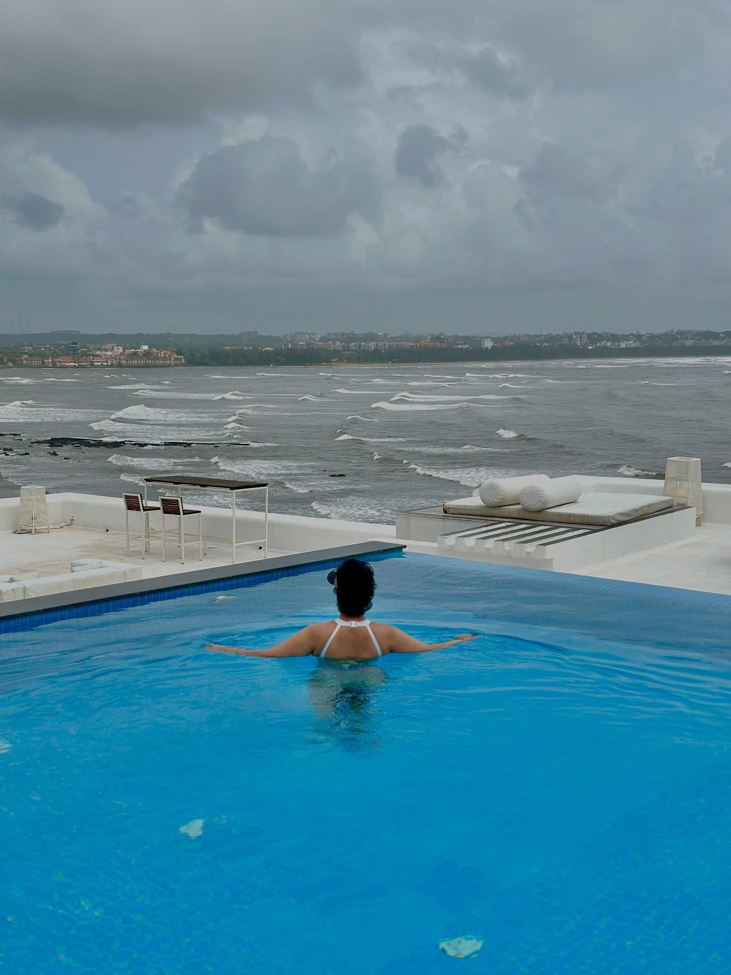 She also took a dig in the luxurious swinging pool at the place she was staying during her vacation. This picture of her in the pool while looking at the sea and the monsoon sky is peace and chaos, both at once.