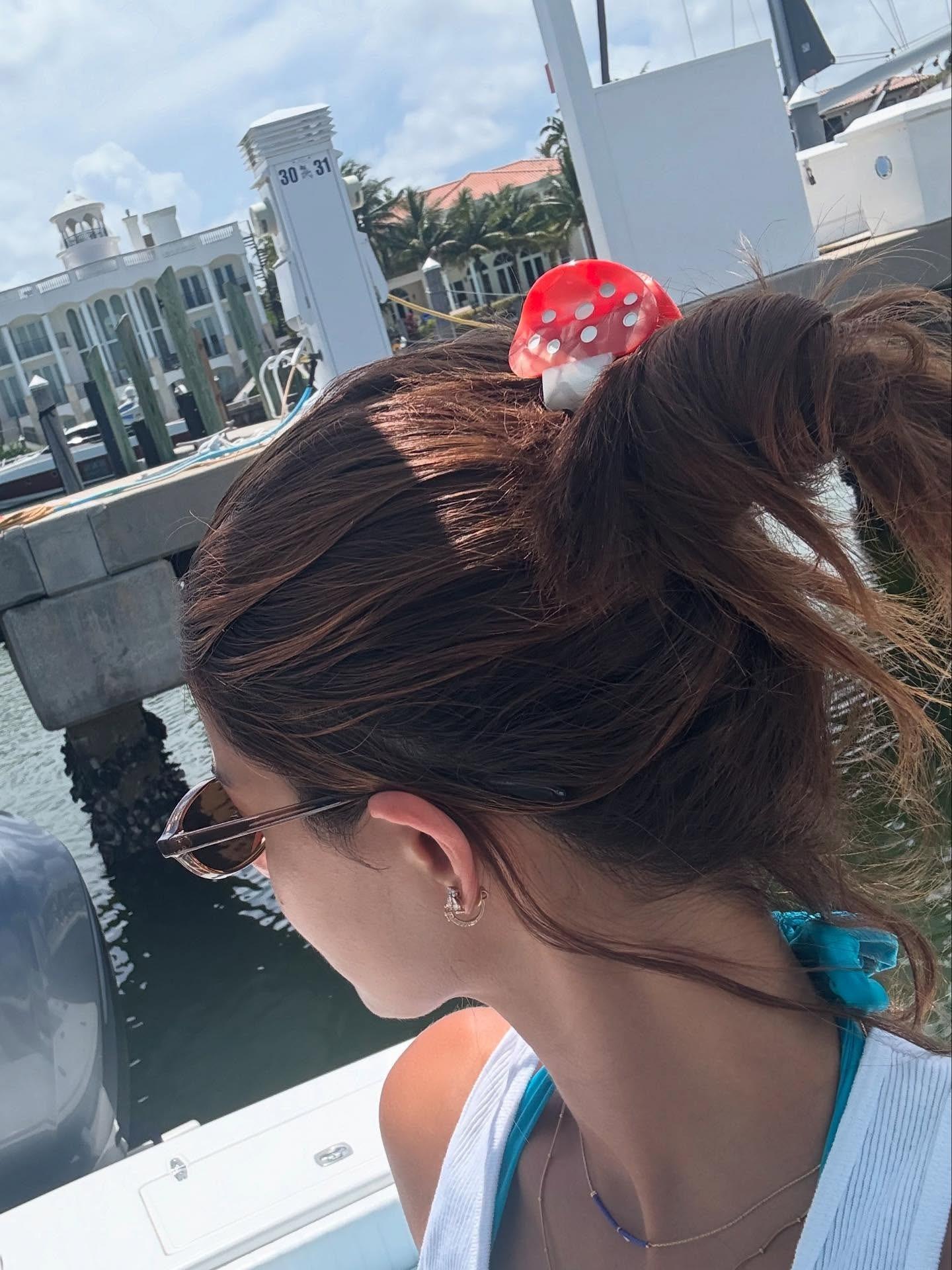 She's clearly a sucker for fancy accessories. This mushroom claw clip is so cute, we'd steal it from her given a chance!