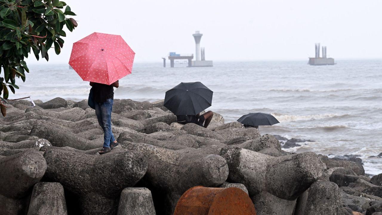 Mumbaikars brace for heavy rain while enjoying the sea view amid a yellow alert issued by the IMD