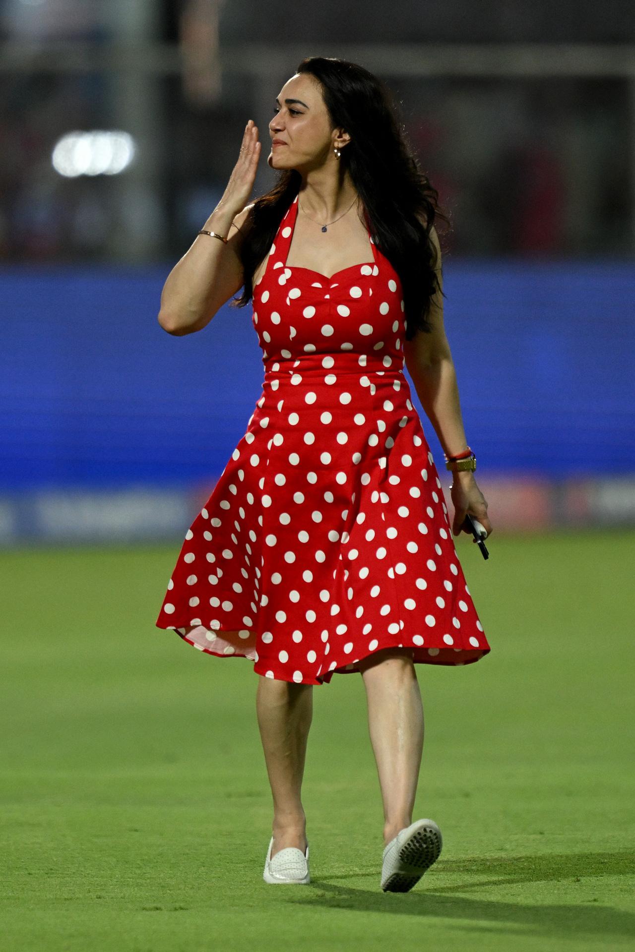 








Oh, that sweetheart neckline with classic polka dots—while keeping the red vibe strong, Preity owning the field and cheering for Punjab Kings is pure iconic energy!






 




