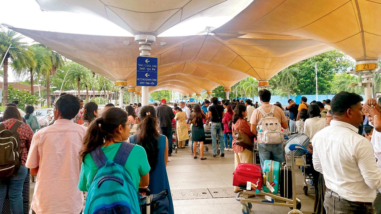 A serpentine queue of passengers waiting for app-based taxis at T1