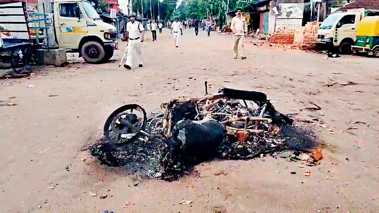 A vehicle set on fire following the violence on Wednesday. Pic/ANI