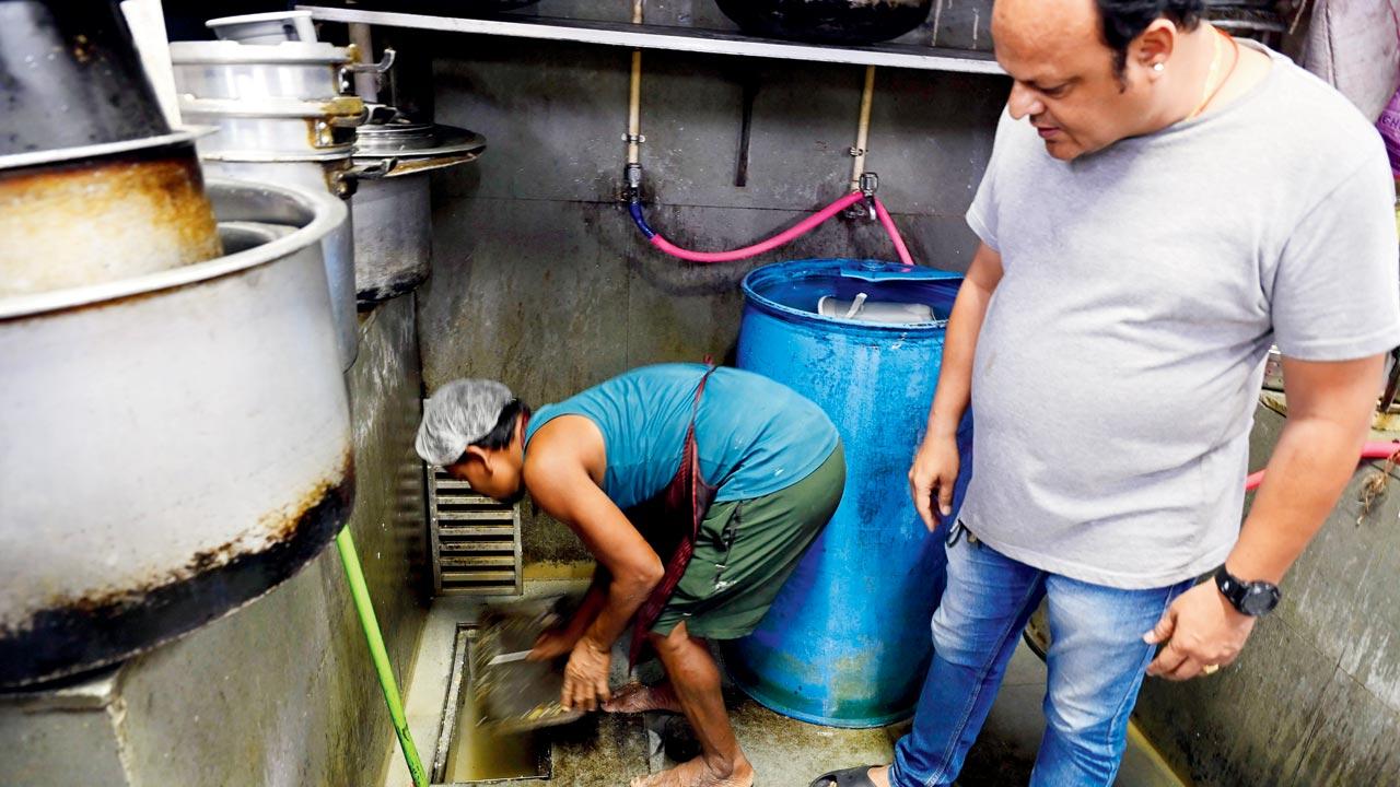 Chetan Karia (right) shows how they hired staff to regularly clean kitchen’s drainage line and installed filters to prevent food waste from clogging it. Pics/Ashish Raje