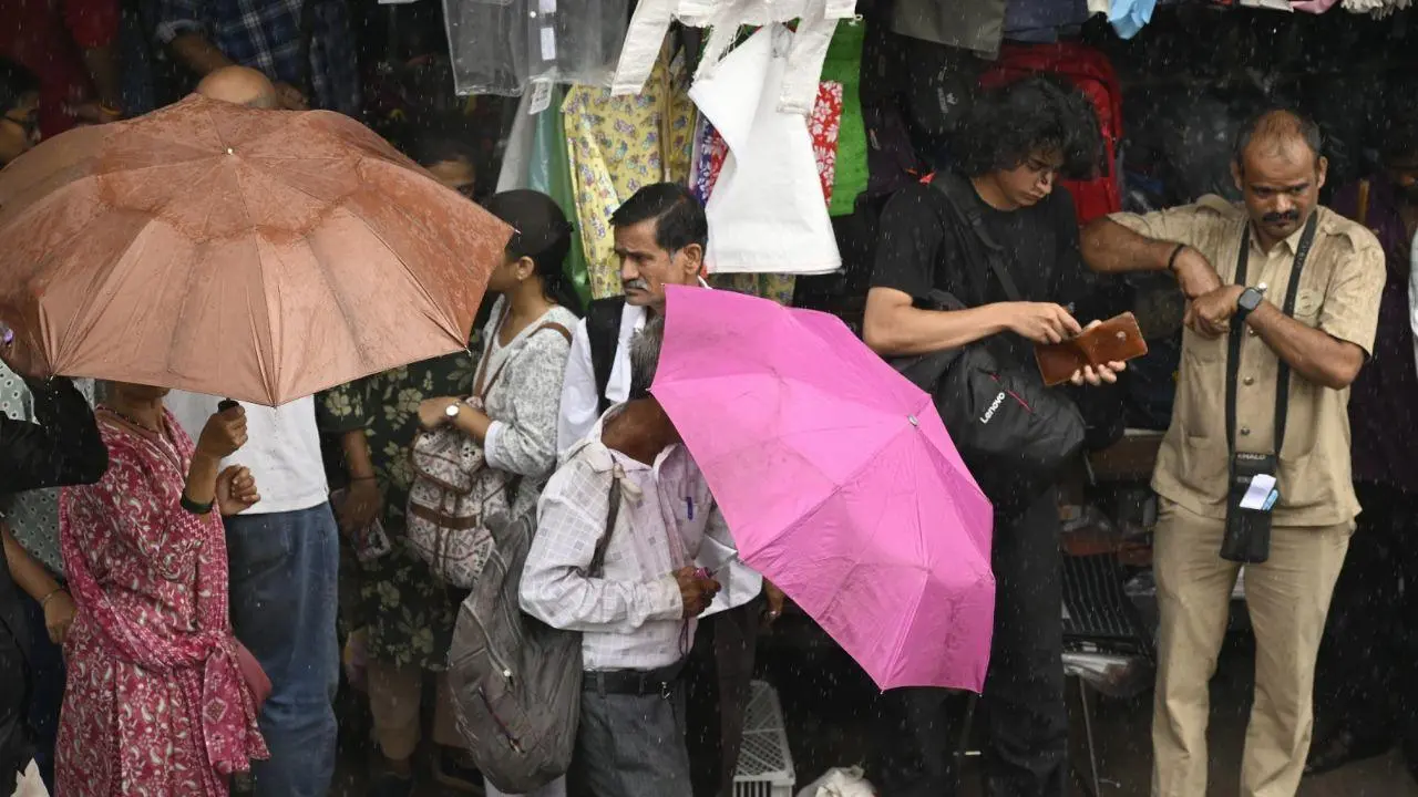 IN PICS: Commuters take cover at Dadar amid rain 