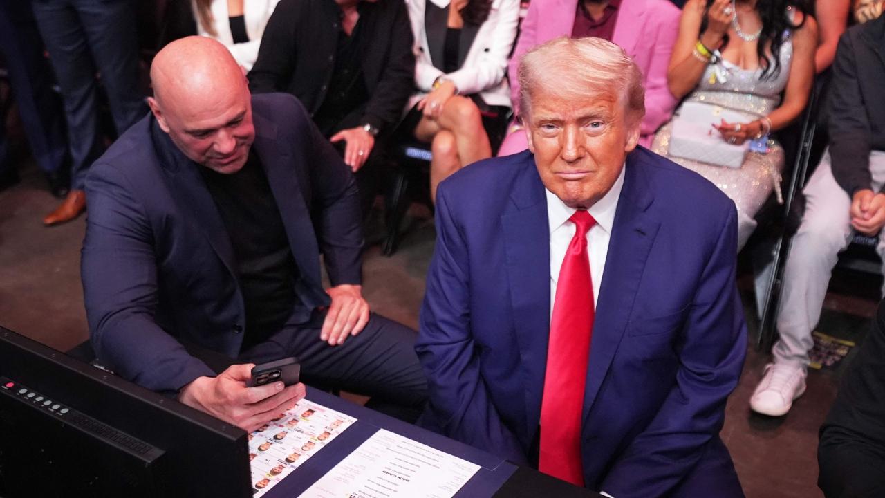 Trump shook hands with fans and supporters, a heavyweight lineup that included retired boxing champion Mike Tyson, on his way to the cage