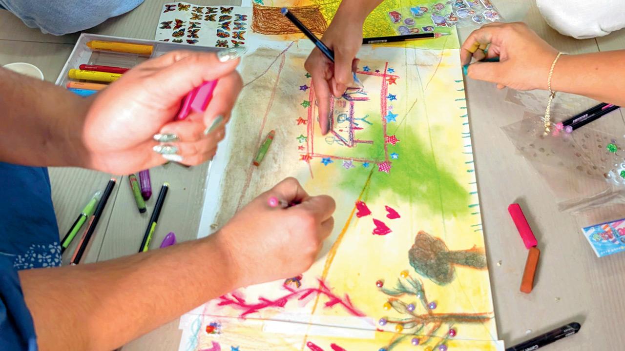 Participants sketch on a canvas