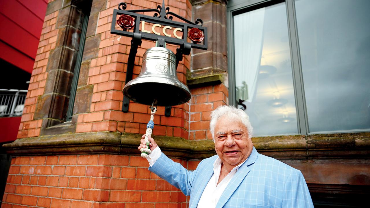Farokh Engineer rings the bell at the start of play in the fourth England-Australia Test at Old Trafford in July 2023. Pic/Getty Images