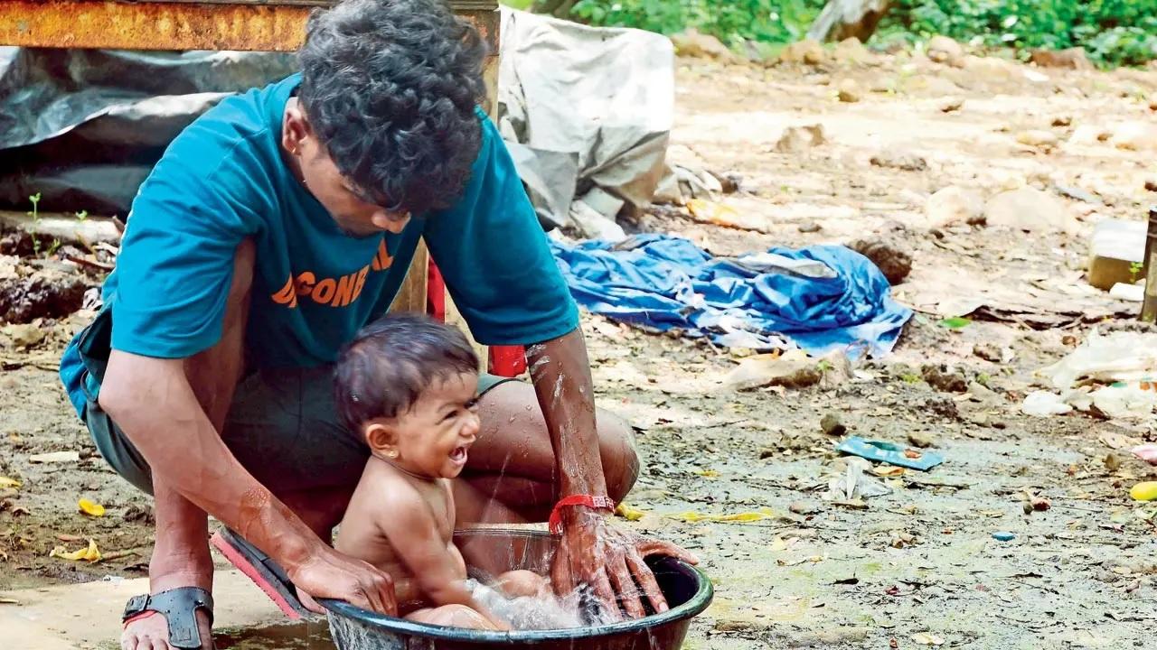 Spending time with your father doesn't require too much just like this enjoyable moment for a child with his dad as he plays with water in a tub in Goregaon East. Pic/Nimesh Dave