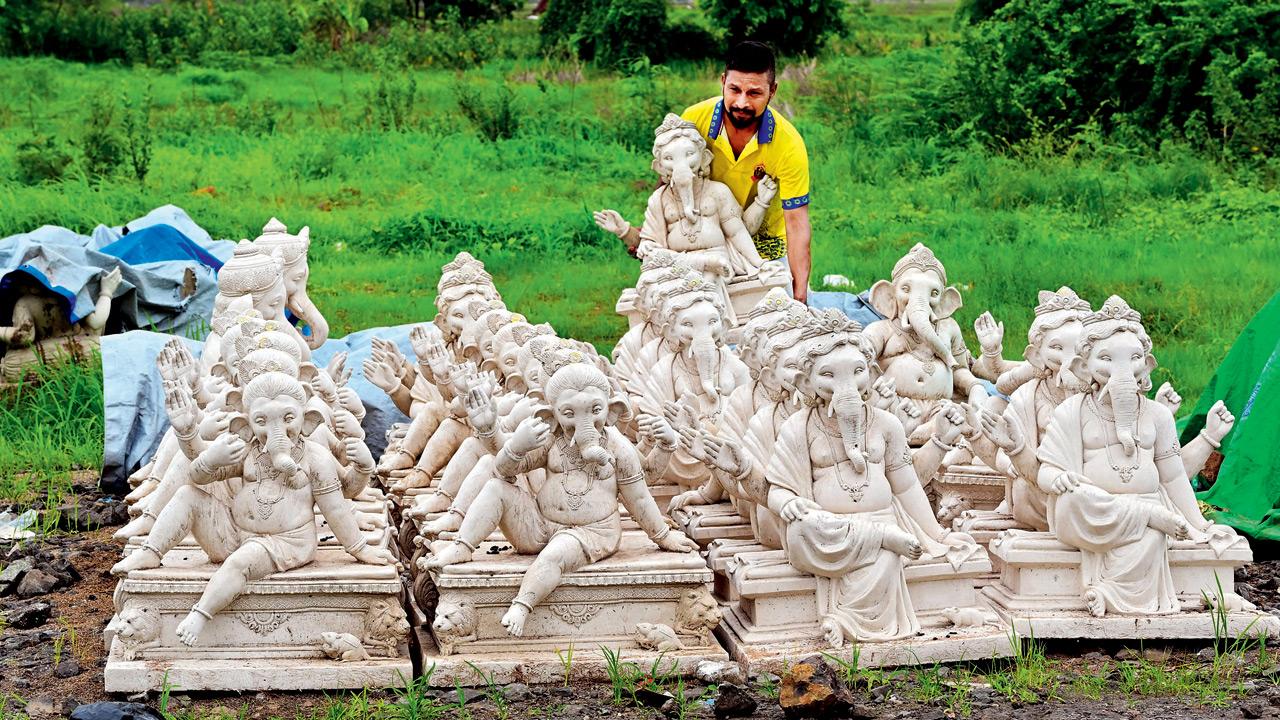 Sculptor Sagar Pawar poses with the idols his factory will ship to the US and UK this season