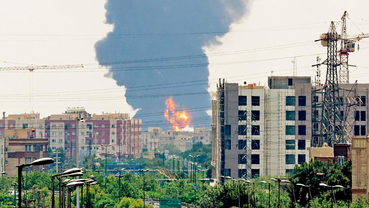 A plume of heavy smoke and fire rises from an oil refinery in southern Tehran, after it was hit in an overnight Israeli strike, on June 15. Pics/AFP