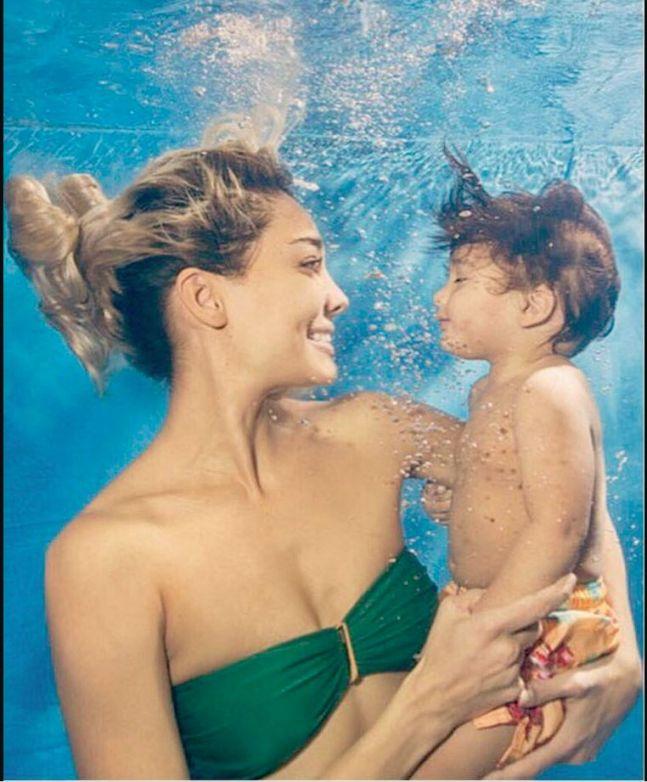 This picture is beyond adorable. It proves that she is a true water baby and leaves no chance to give her kids a taste of the sea life.