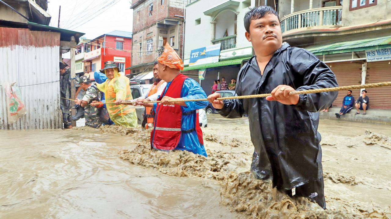 People being rescued in flood-hit Imphal dictrict. Pic/PTI