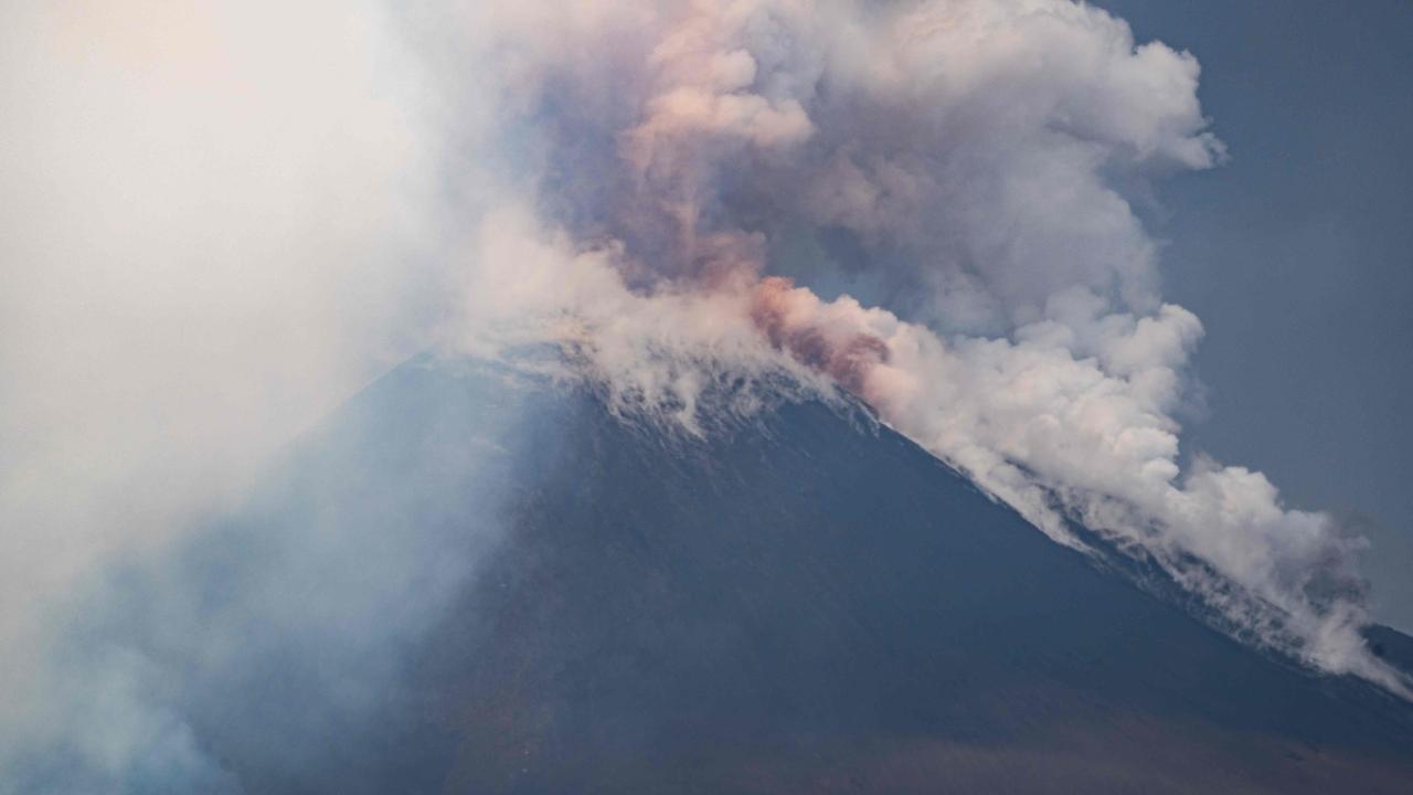 Video showed tourists running along a path on the flank of the vast volcano with smoke billowing some distance in the background