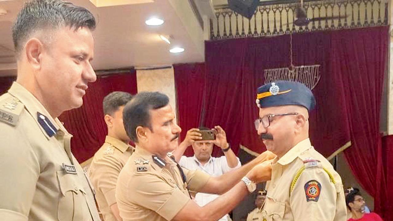 Mahesh Patil, regional additional commissioner of police, promotes an officer from the rank of head constable to assistant police sub-inspector on June 2. Pic/By Special Arrangement
