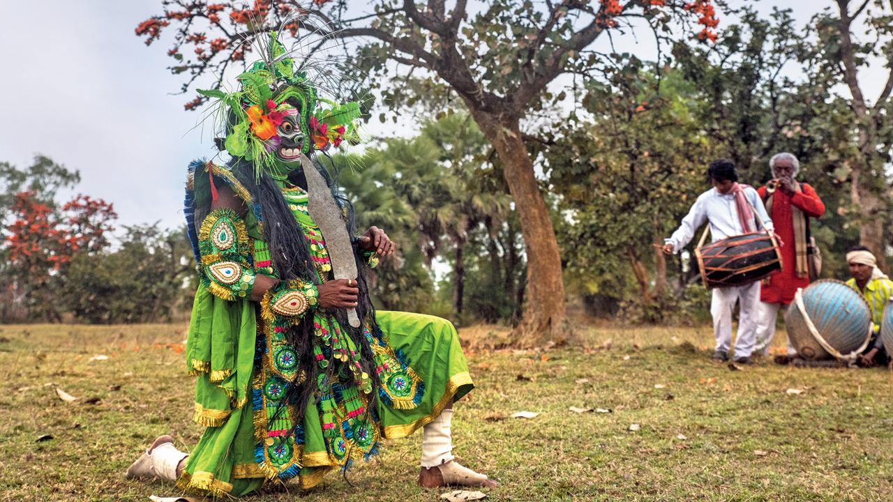 A performer strikes a pose during a show in Purulia