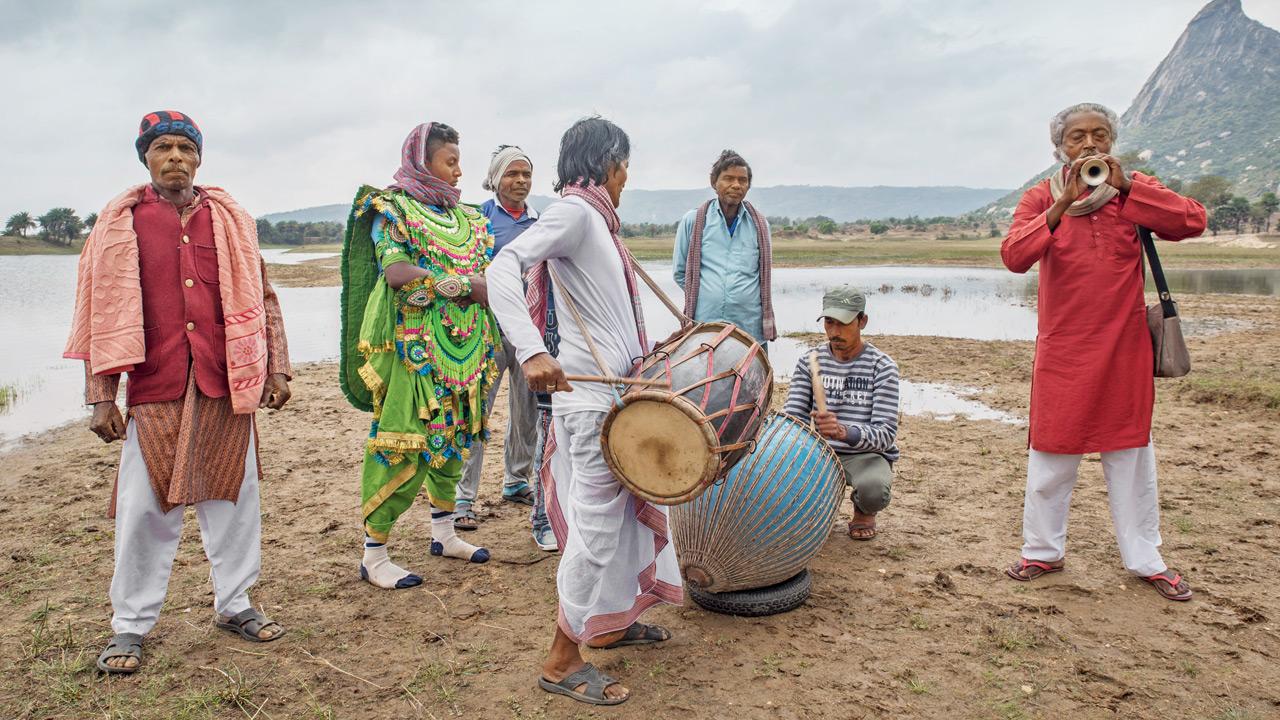 A troupe of musicians rehearse before a show