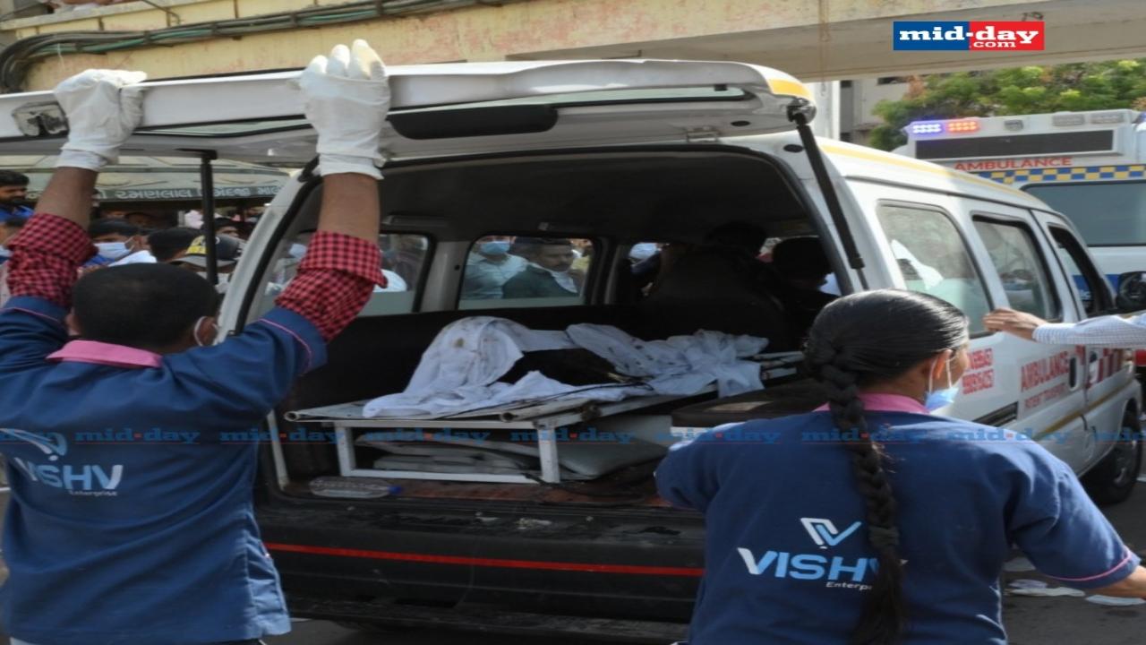 An ambulance prepares to move a body from the site 