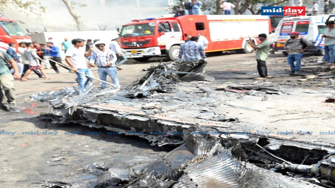 Emergency responders use tools to access trapped sections of the mangled aircraft