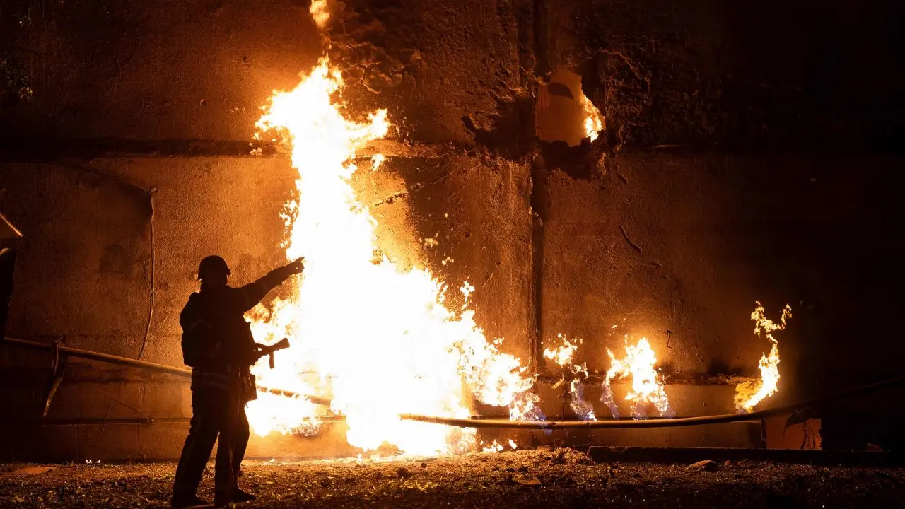 A firefighter at the sight of the drone strike in Kharkiv, Ukraine, on Thursday. Pic/AFP
