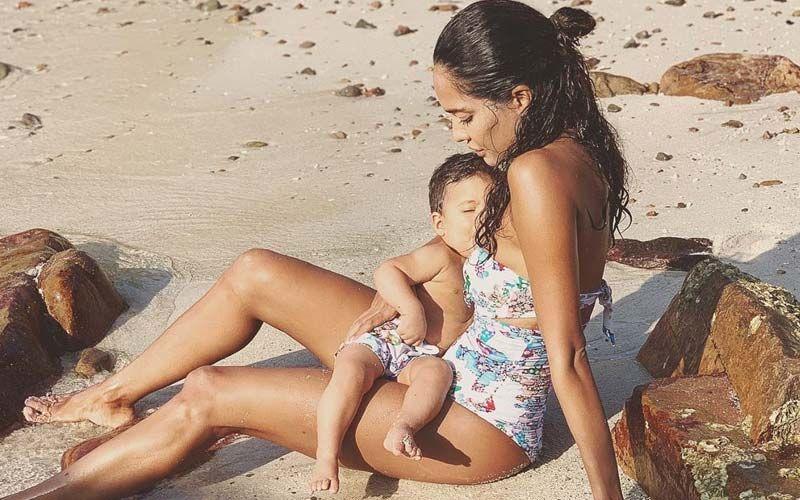 Mother is mothering quite literally! The way she finds ways to embrace and care for her kids, while making sure they experience the beachlife. 