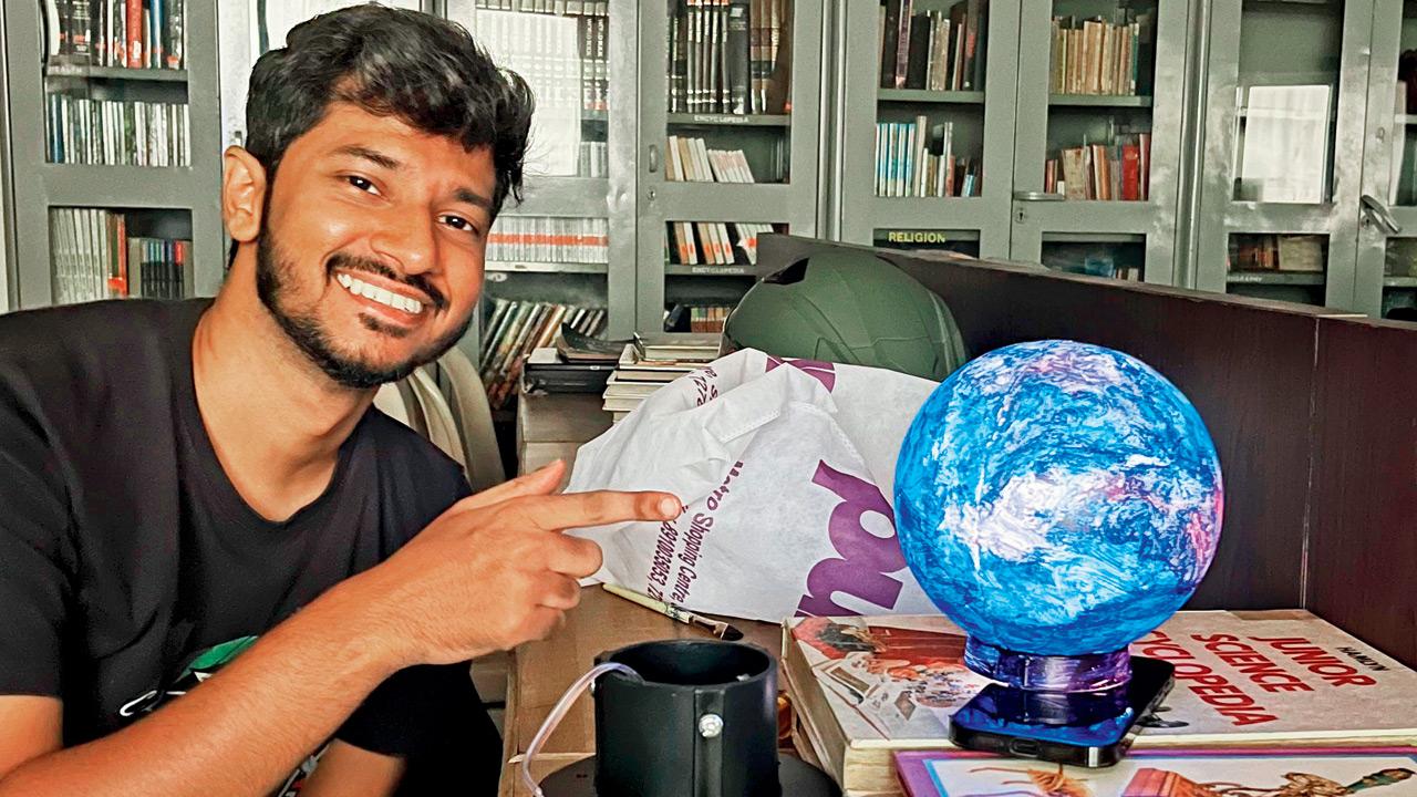 Shilton Dmello with a revamped globe installation at the laboratory.  PIC COURTESY/SHILTON DMELLO