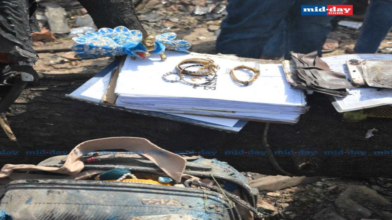 Rescue teams gather personal belongings of passengers from the crash site