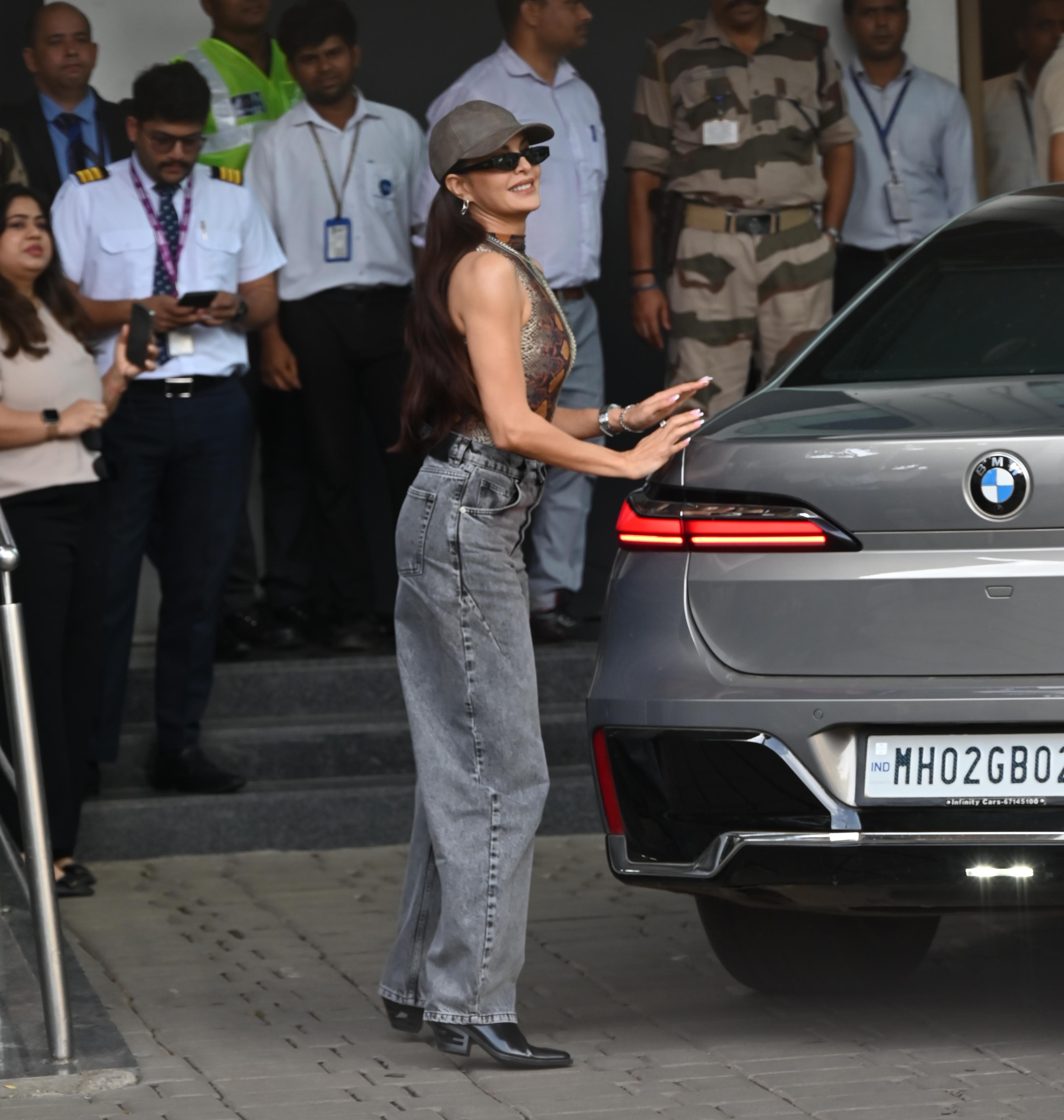 Jacqueline Fernandez looked cute in a strappy crop top paired with loose straight-fit grey pants. She accessorized her look with a cap and sunglasses