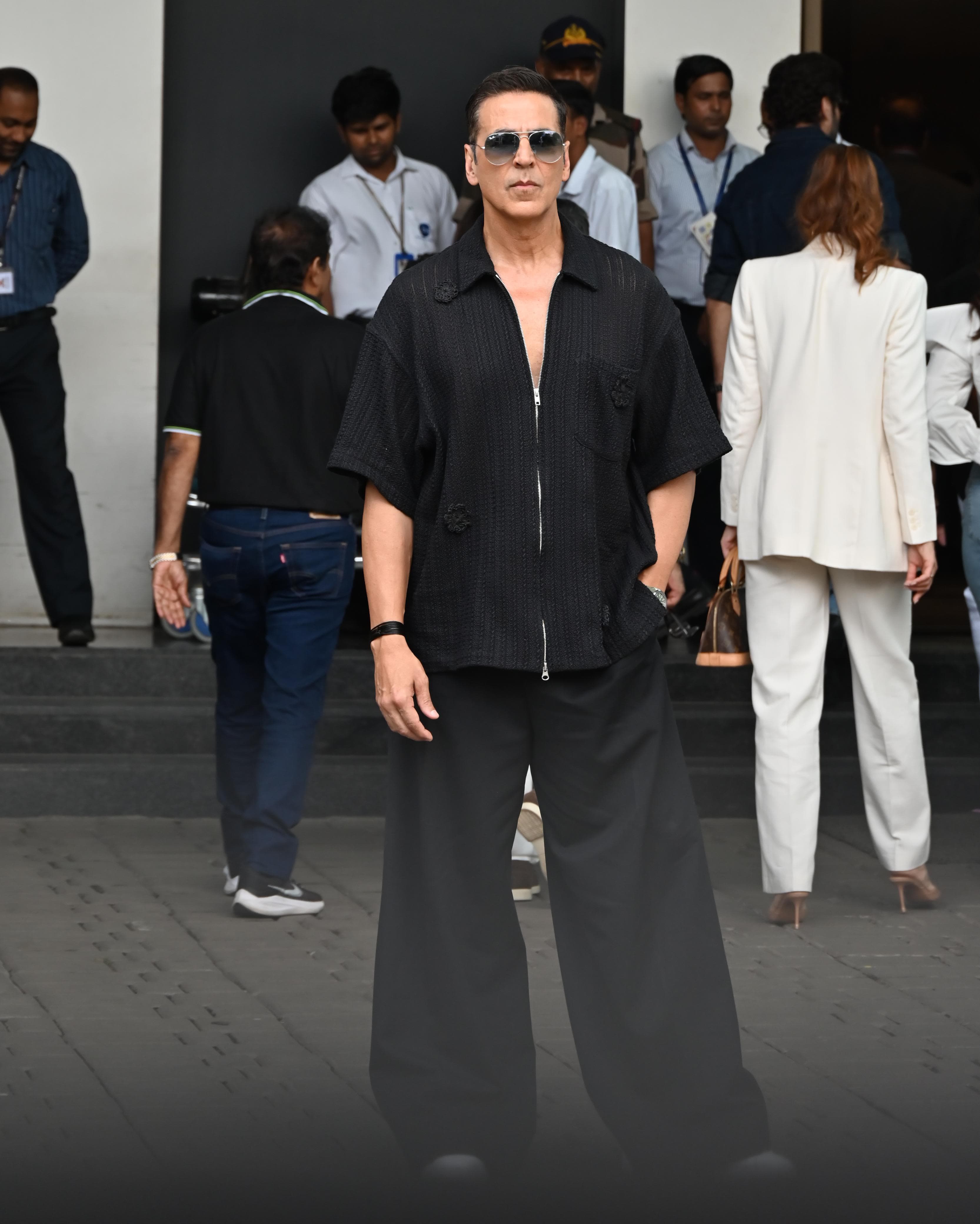 Akshay Kumar looked smart in a black-on-black outfit as he was snapped at Mumbai airport. The actor wore wide-legged pants and paired them with a zip-up shirt