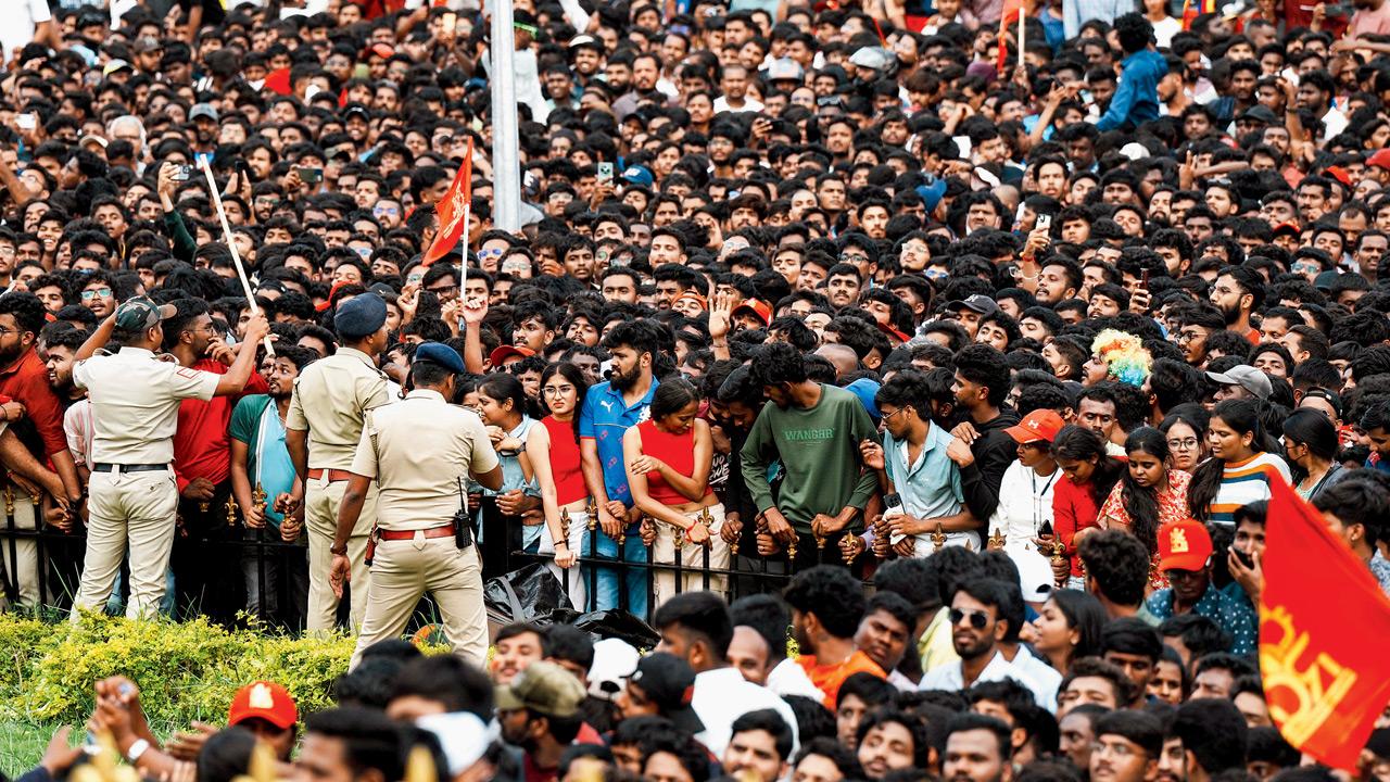 Fans gather outside the stadium for RCB’s felicitation ceremony, while some can be seen pressed against the stadium’s entrance gate, yesterday