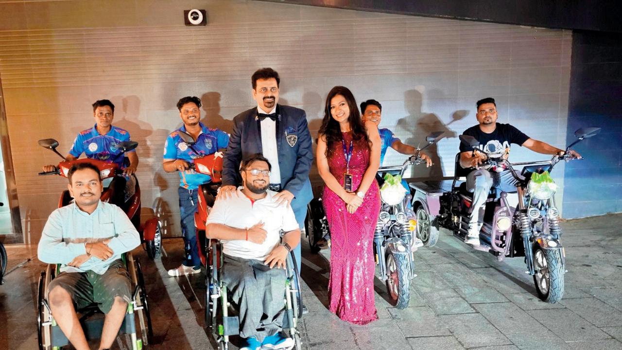 Rahul Ramugade (centre) receives the e-bikes with his teammates at a Vile Parle venue. PIC COURTESY/SHALINE SERPES