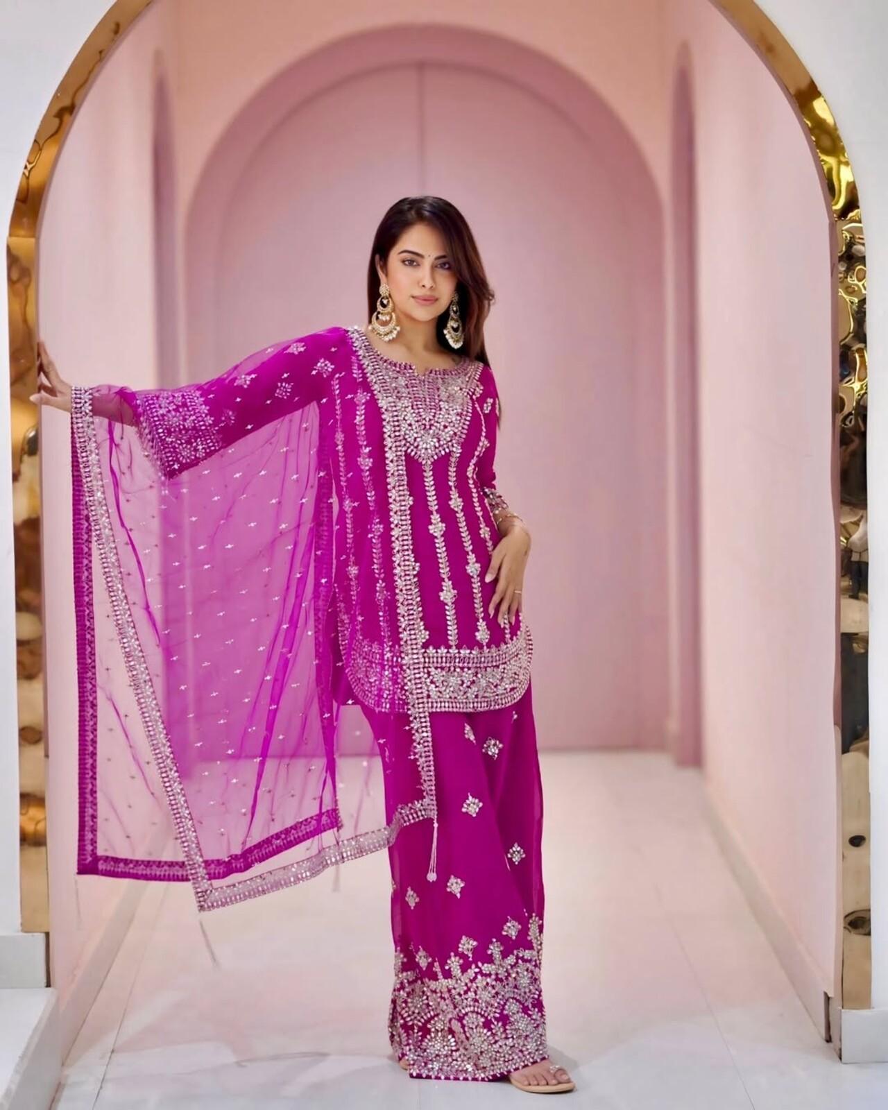 Draped in a vibrant pink sharara set with heavy mirror embellishments, Avika channeled desi glamour. The sheer dupatta and statement earrings add a dazzling, festive vibe to the ensemble