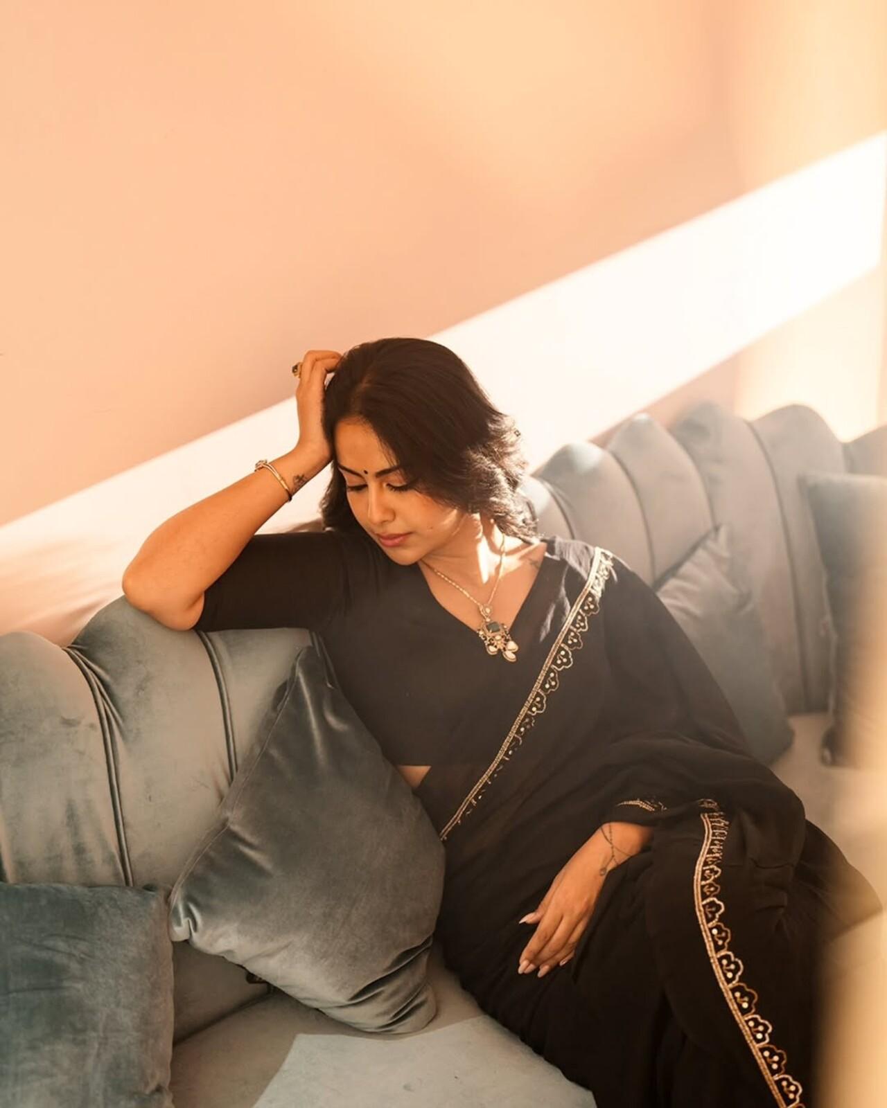 Draped in a classic black saree with a barely-there shimmer, she exudes quiet elegance and cinematic grace. Styled with striking emeralds, her minimal look speaks volumes—proving that understated choices can still leave the strongest impression