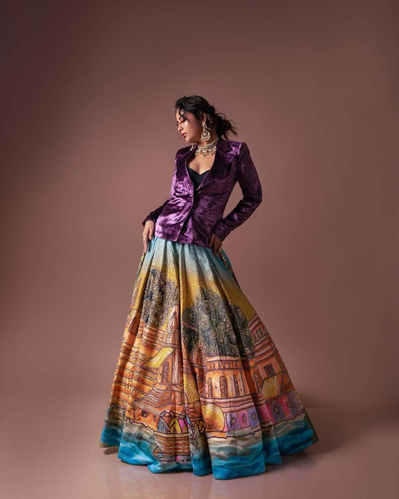 She brought runway drama in this hand-painted lehenga teamed with a royal purple velvet jacket. The black bustier and ornate jewellery deliver a bold contrast that’s editorial-worthy